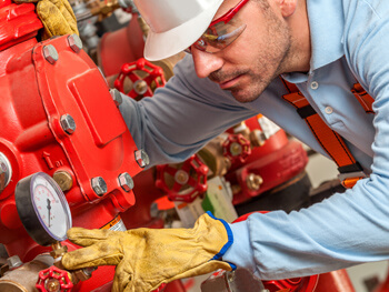 Technician servicing fire prevention equipment